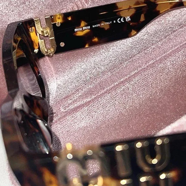 Miu Miu Women's Cat eye Sunglasses - Brown/Black in red|black|brown from Depop, photo 5 of 6