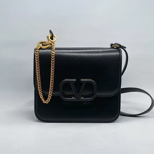 Valentino Garavani Small Vsling Leather Shoulder Bag in black|gold Leather from Poshmark, photo 1 of 1