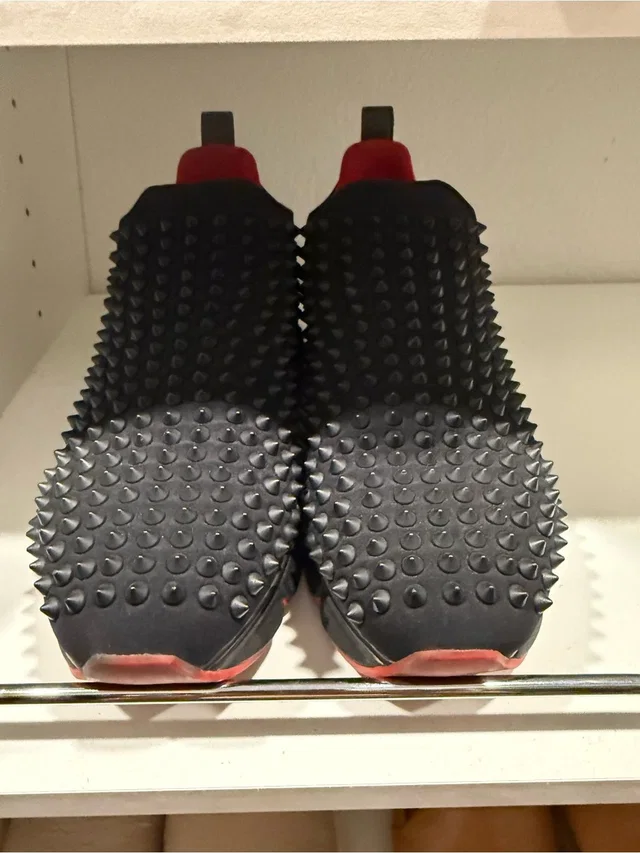 Christian Louboutin Black Studded Slip-On Sneakers With Red Accents in black|red from Poshmark
