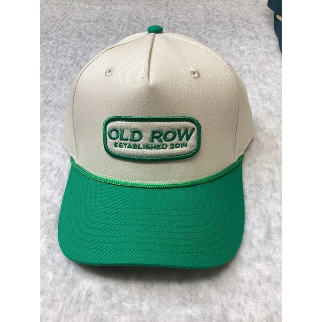 The Row Men's Caps - Cream/Green in green from Depop, photo 1 of 1