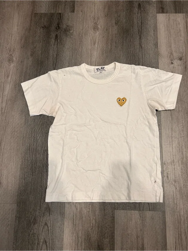 Comme des Garçons Comme Des Garons Play White T-Shirt With Black Neck Label in gold|white from Poshmark, photo 1 of 1