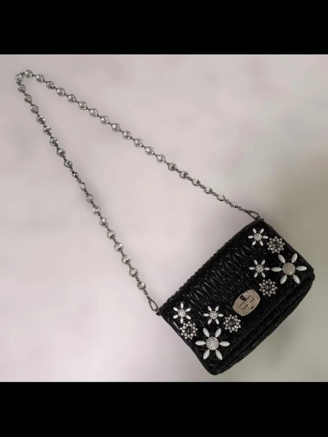 Miu Miu Black Woven Floral Crystal Chain Crossbody in black|white Woven leather from Poshmark, photo 1 of 1