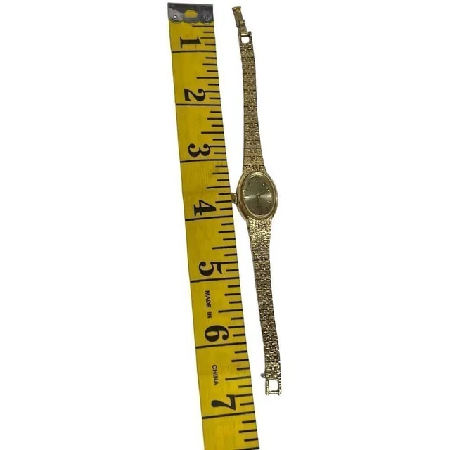 Seiko Women's Gold Tone Mechanical Movement Oval Champagne Stick Dial Wristwatch in gold Satin from Poshmark
