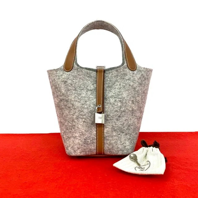 Hermès With Key Picotin Lock PM Felt Swift Leather Handbag Gripaire Gold in Gold Swift leather from The Reluxe
