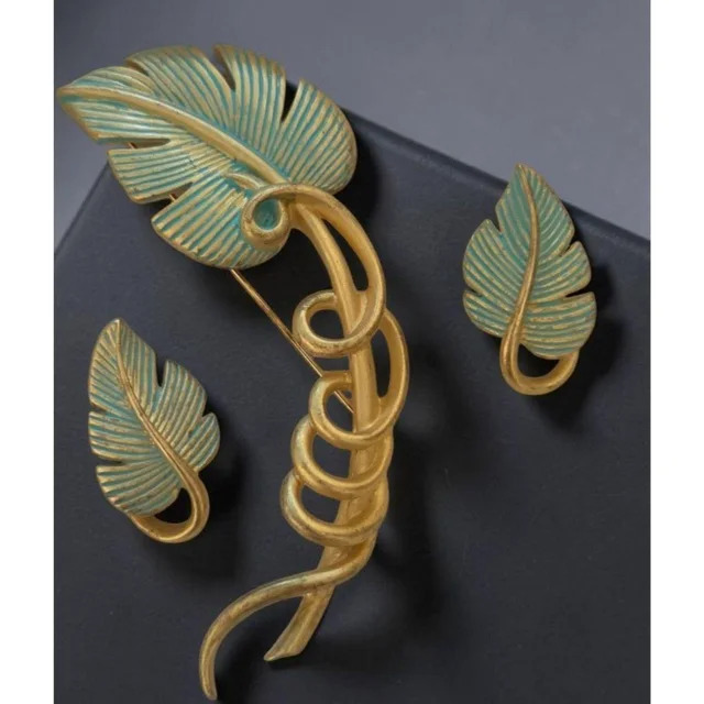 Givenchy Women's Brooch - Gold/Green in gold|green from Depop, photo 1 of 1