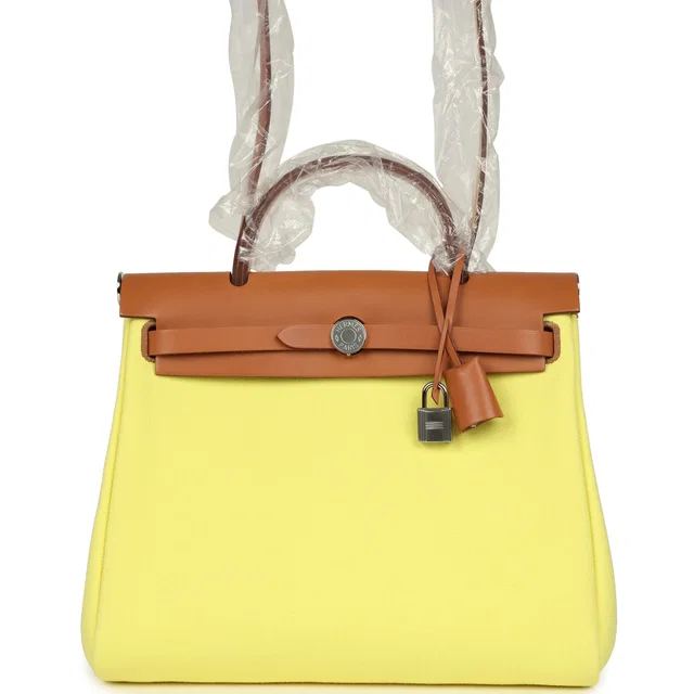 Hermès Herbag Zip PM 31 Jaune Citron Toile H Canvas, Fauve Vache Hunter Palladium Hardware in Yellow Canvas from Madison Avenue Couture